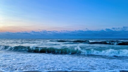 A serene ocean scene at dusk with gentle waves and a colorful sky.