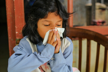 a girl from Indonesia is sad because of the flu