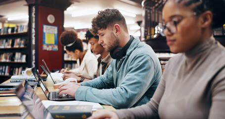 Education, laptop and typing with student friends in library of university together for learning or...