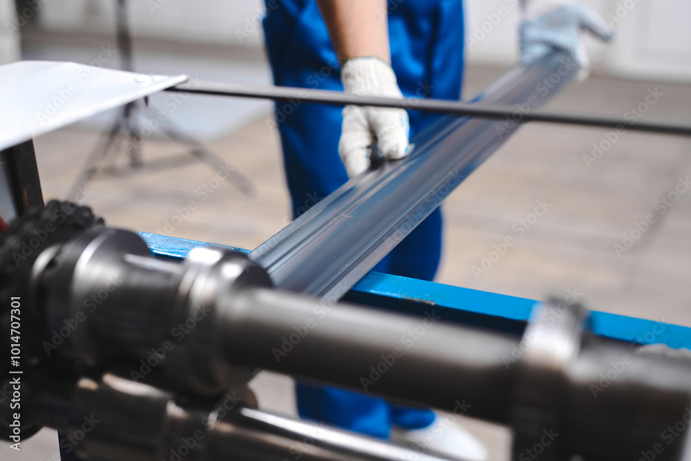 Wall mural professional engineer man in blue uniform works in factory. rolled metal, metal processing and manuf