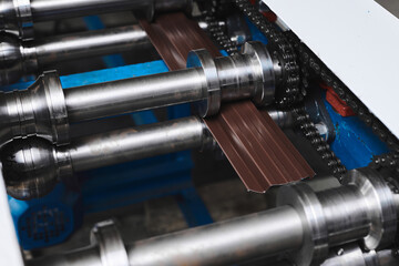 Rolled metal, metal processing and manufacturing of metal fence, close-up of metal rolling equipment at the factory