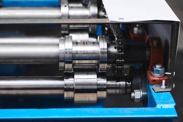 Rolled metal, metal processing and manufacturing of metal fence, close-up of metal rolling equipment at the factory