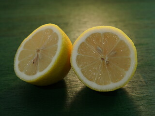 sliced ​​lemon fruit on green wooden board