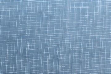 Abstract blue background with white grid pattern resembling chalk lines.