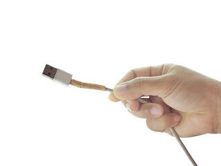 Female hand holding USB power cord, power plug isolated on transparent background.