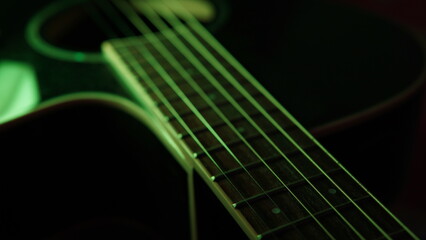 guitar background. selective focus. guitar on a dark background with a hint of green light. guitar...