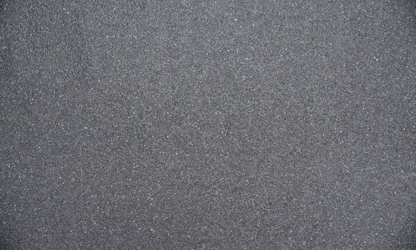 Texture of gray asphalt marble chips on flat roof