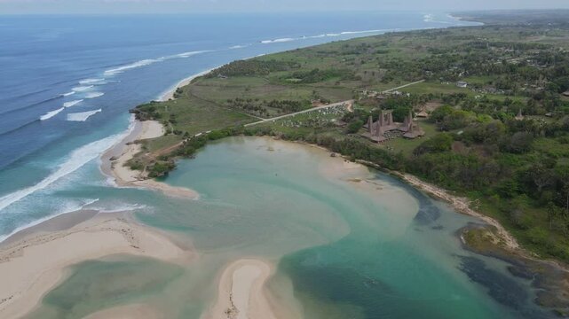 Traditional buildings at ocean coastline at sunny day. Sumba island. Indonesia