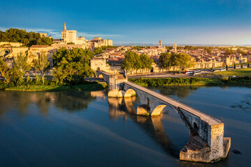Beautiful view of Avignon with famous bridge Saint-Benezet, medieval architecture along the Rhone River in Avignon, France. The Pont Saint Benezet and the Papal palace in Avignon, South France.