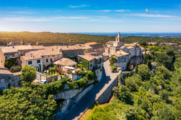Obraz premium View of Venasque village with old church Notre Dame de Vie to landscape of Luberons, Provence, France. Beautiful Church and houses in the town of Venasque, Provence, France.