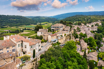 Fototapeta premium Menerbes village in Provence on a summer day, France, Luberon, Vaucluse. Village of Menerbes, the village and the Luberon mountains also called the most beautiful village of Luberon, France, Provence.