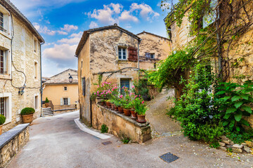 Charming street in quaint Menerbes village with colorful buildings and vibrant flowers. Village of Menerbes (Most Beautiful Village in France) in the Luberon mountains, France, Luberon, Vaucluse. © daliu