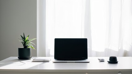 A minimalist workspace featuring a laptop, plant, and stationery by a window.