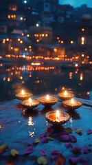 Fototapeta premium A group of candles are lit on a table by a body of water. The candles are arranged in a row