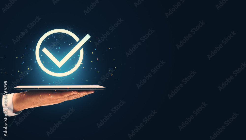Poster Check mark icon displayed on tablet in hand against dark background.