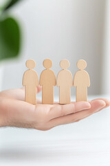 Person holding wooden figures representing family dynamics in systemic constellations therapy session