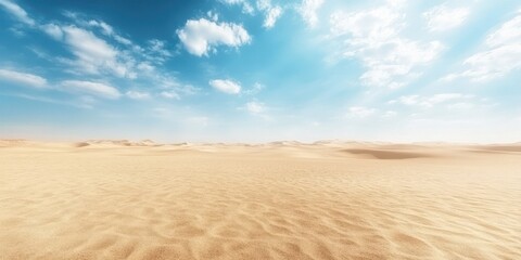 Naklejka premium Expansive desert landscape under a bright blue sky with fluffy clouds and gentle sand dunes, showcasing nature's tranquility.