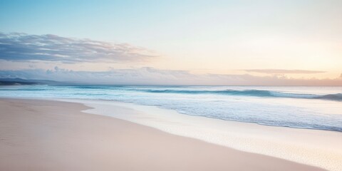 Fototapeta premium A serene beach landscape at sunrise, featuring gentle waves and soft sands, ideal for a peaceful retreat and relaxation.