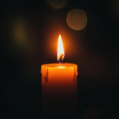 Close-up of a candle flame flickering in a darkened room during Yom Kippur, symbolizing reflection and spirituality. Shallow depth of field, warm light contrasting with shadows.