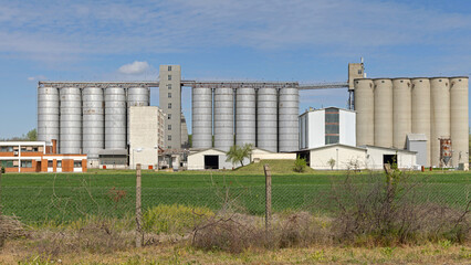 Tall Metal and Concrete Silo Grain Storage Farm Buildings Blue Sky Spring Day © markobe