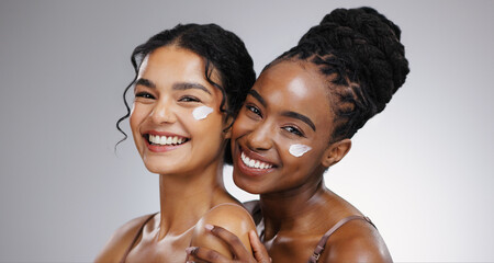 Portrait, cream and women with skincare, cosmetics and dermatology on white studio background. Face, friends and people with lotion, aesthetic and grooming routine with treatment, shine and beauty
