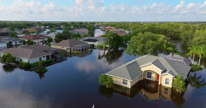 Flooding in Florida caused by tropical storm from hurricane Debby. Suburb houses in Laurel Meadows residential community surrounded by flood waters in Sarasota. Aftermath of natural disaster.