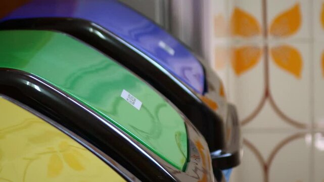 Recycle bins with hand dropping a glass bottle