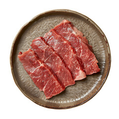 Fototapeta premium Freshly Cut Raw Beef Slices Arranged on a Round Plate.