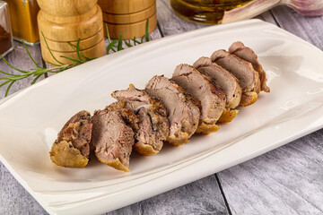 Roasted duck breast slices in the plate