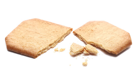 Sugar coated cinnamon biscuits, broken and crumbs isolated on white