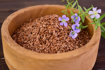 Flax seeds in a wooden bowl. Close-up.Selective focus.	