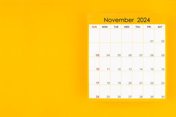 November 2024 caledar page on yellow background, Position with copy space.