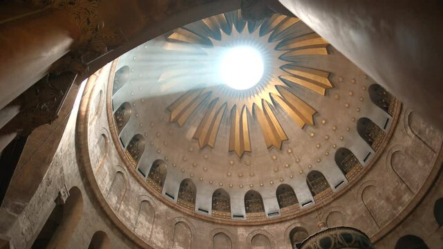 A remarkable phenomena caused by the light beam, penetrating the inside dome at the Church of the Holy Sepulchre. a wide angle shot inside the holy Church. a 4K clip, July 2nd, 2024, Jerusalem, Israel