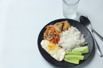 ried Egg with Rice, Vegetables, Tofud and Cucumber Slice. Top View. Isolated White Background.