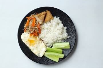 ried Egg with Rice, Vegetables, Tofud and Cucumber Slice. Top View. Isolated White Background.