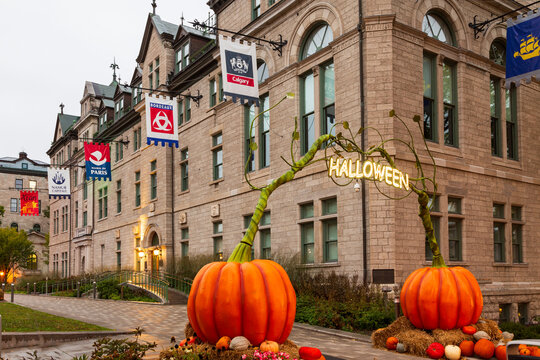 Quebec City, Quebec, Canada, October 6, 2024 -&nbsp;Giant pumpkin Halloween arch at the entrance to the late 19th Century stone chateauesque City Hall gardens