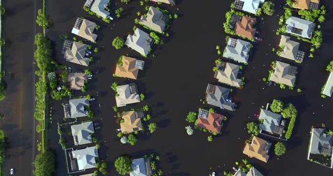 Flooding in Florida caused by tropical storm from hurricane rainfall. Suburb houses in residential community surrounded by flood waters. Aftermath of natural disaster.