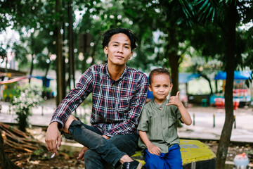 Southeast Asian father chatting with his child, capturing a moment of connection and care