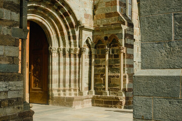 the facade and details of the facade of a medieval fortress in Europe. A monastery in northern Italy