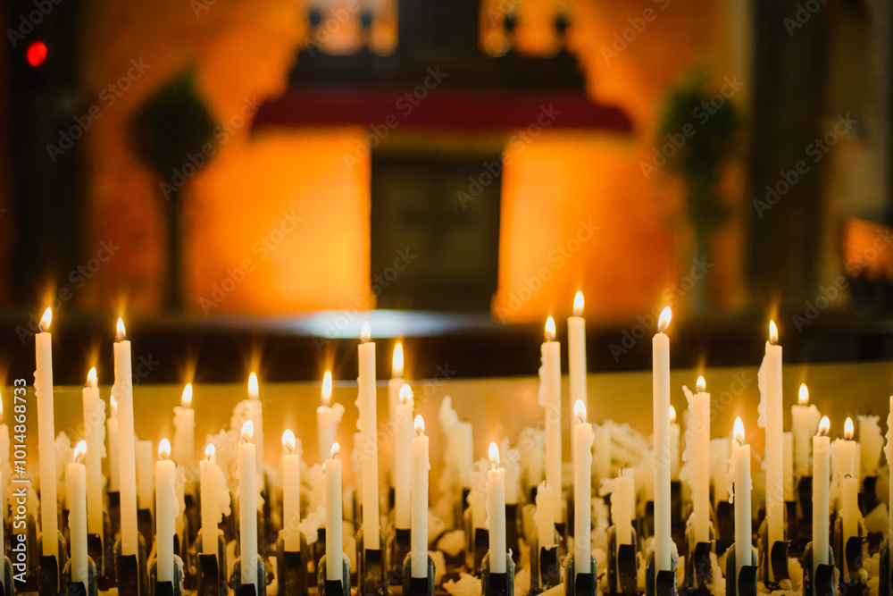 Wall mural burning candles in church