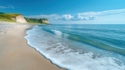 Scenic beach with gentle waves and a clear sky, viewed from a low angle perspective, highlighting the tranquility and beauty of the coastal scene 