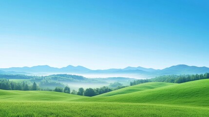 Serene Landscape of Rolling Hills and Distant Mountains Under a Clear Blue Sky