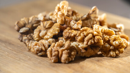 Peeled walnut kernels close-up on wooden background, Selective focus, tinted image.