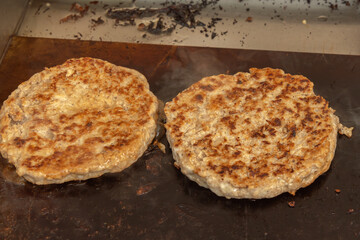 Burger meat steaks are cooked on hot coals. Close-up