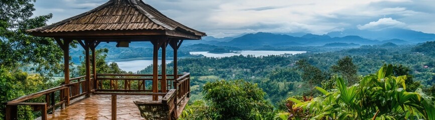 Wooden gazebo overlooking a lake and mountains.