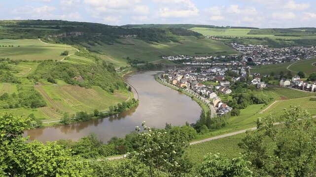 View from Grevenmacher vineyards in Luxembourg onto landscape with Moselle River and the towns of Machtum and Nittel on a sunny day