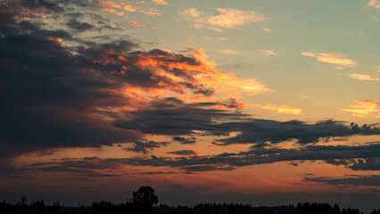 Real majestic sunrise sundown sky background with gentle colorful clouds .