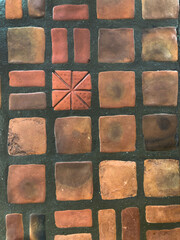 Brown traditional ceramic floor or wall tile as background texture. Geometric tile details. Stone...