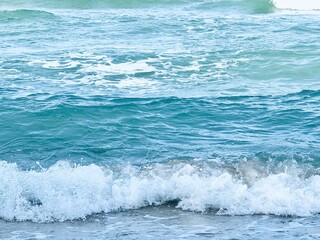 Wave of sea with white foam. water splash in the sea. Splash sea. Clear water and white sand