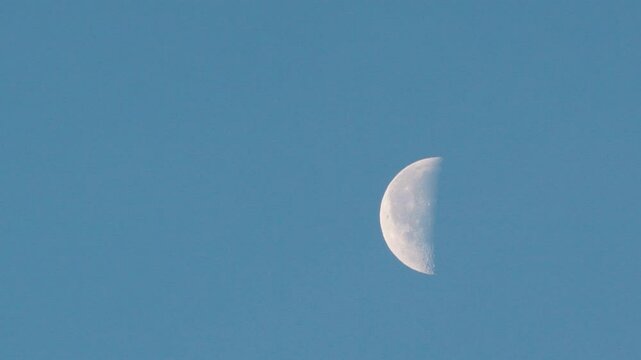 Half moon on blue sky during daylight.
